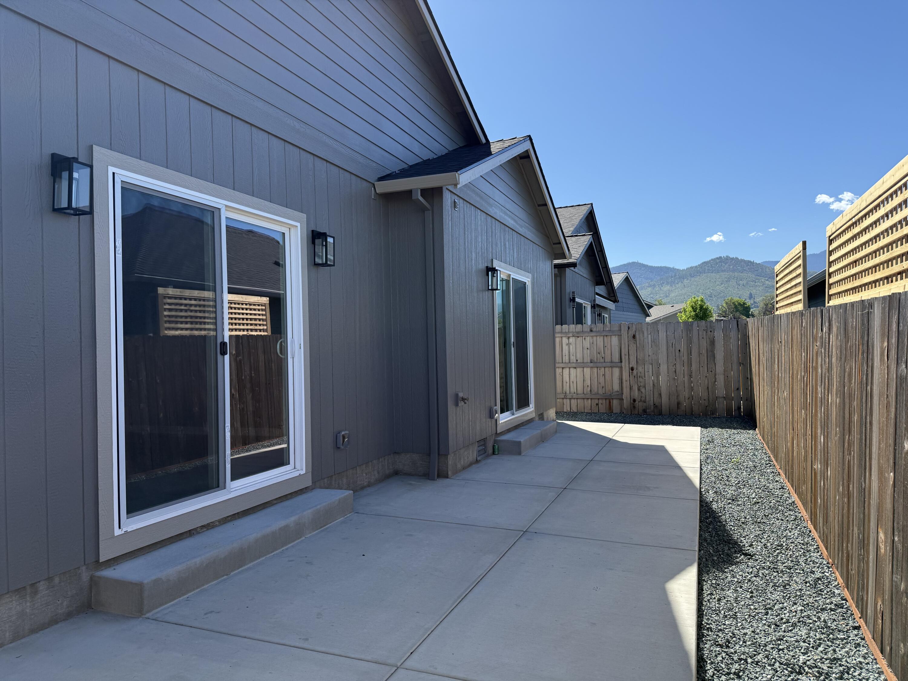 337 Quail Circle Talent, OR 97540 - Photo 22 of 25 a view of backyard with small cabin and wooden fencing