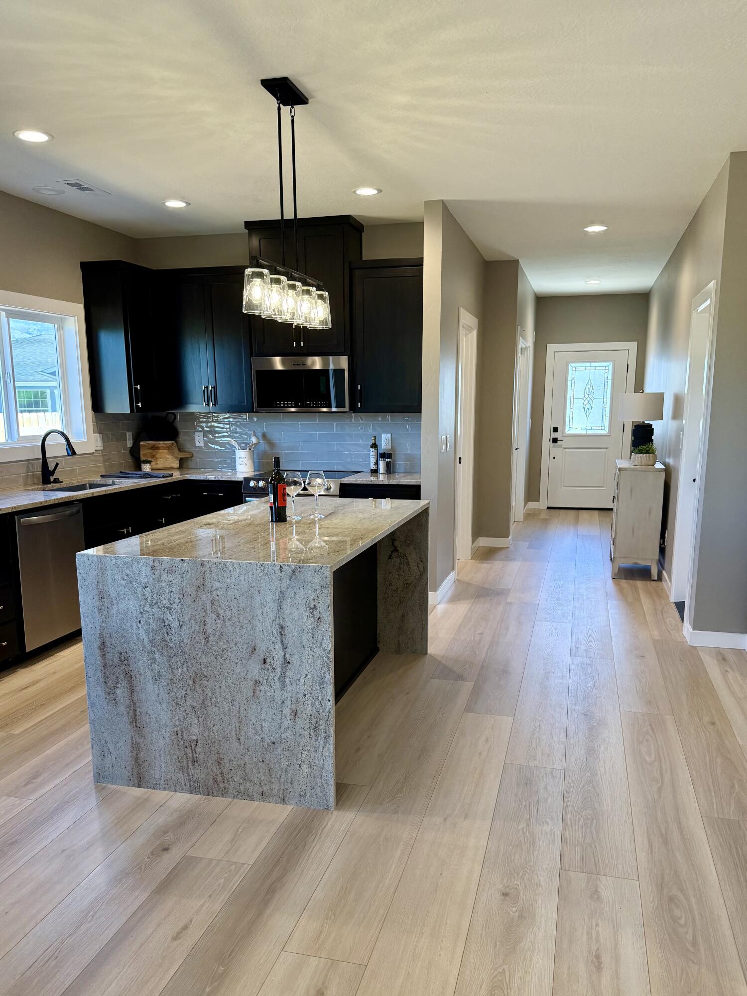337 Quail Circle Talent, OR 97540 - Photo 6 of 25 a living room with stainless steel appliances granite countertop a couch wooden floors and a view of living room