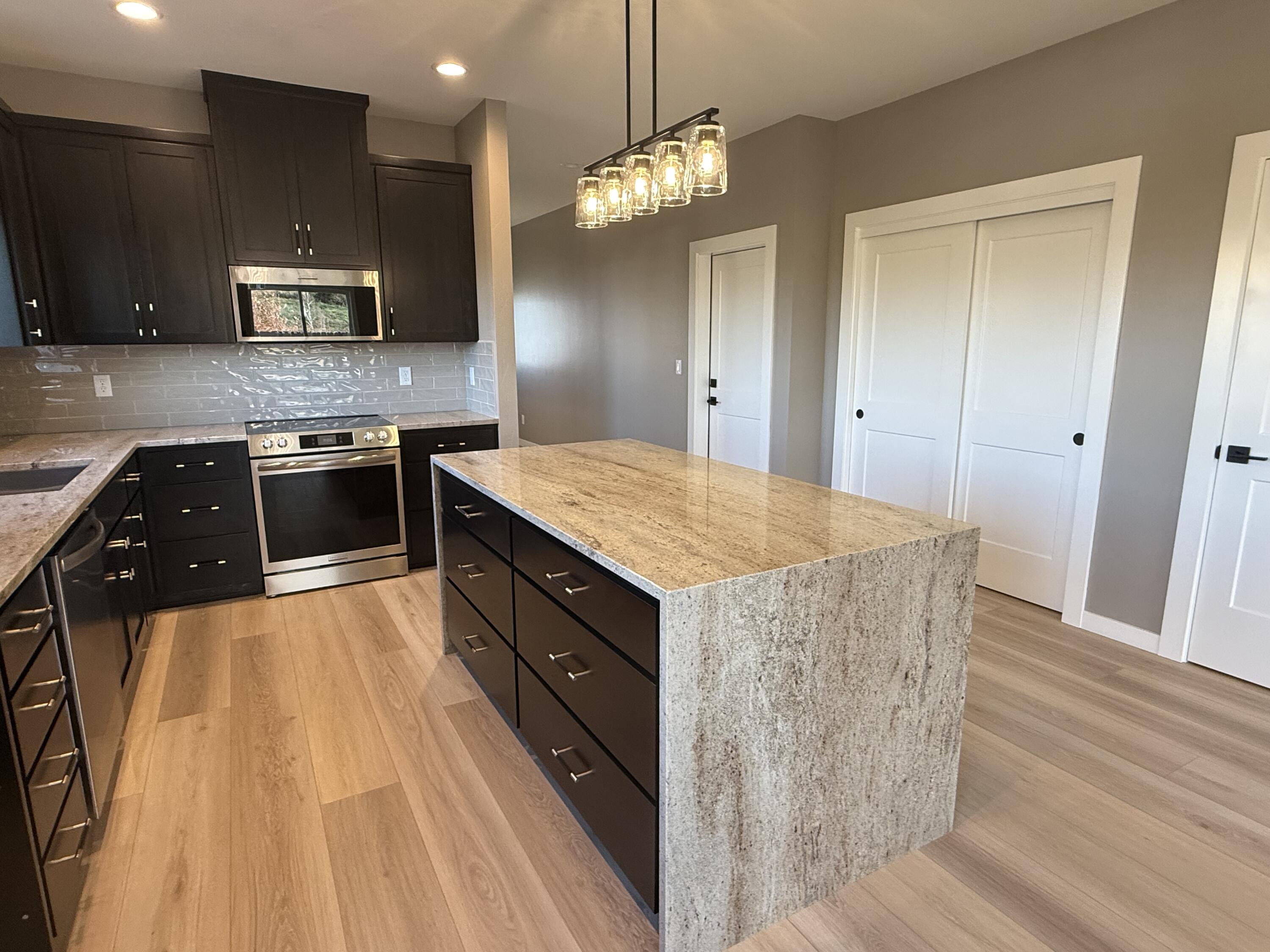 337 Quail Circle Talent, OR 97540 - Photo 7 of 25 a kitchen with a sink and a stove top oven