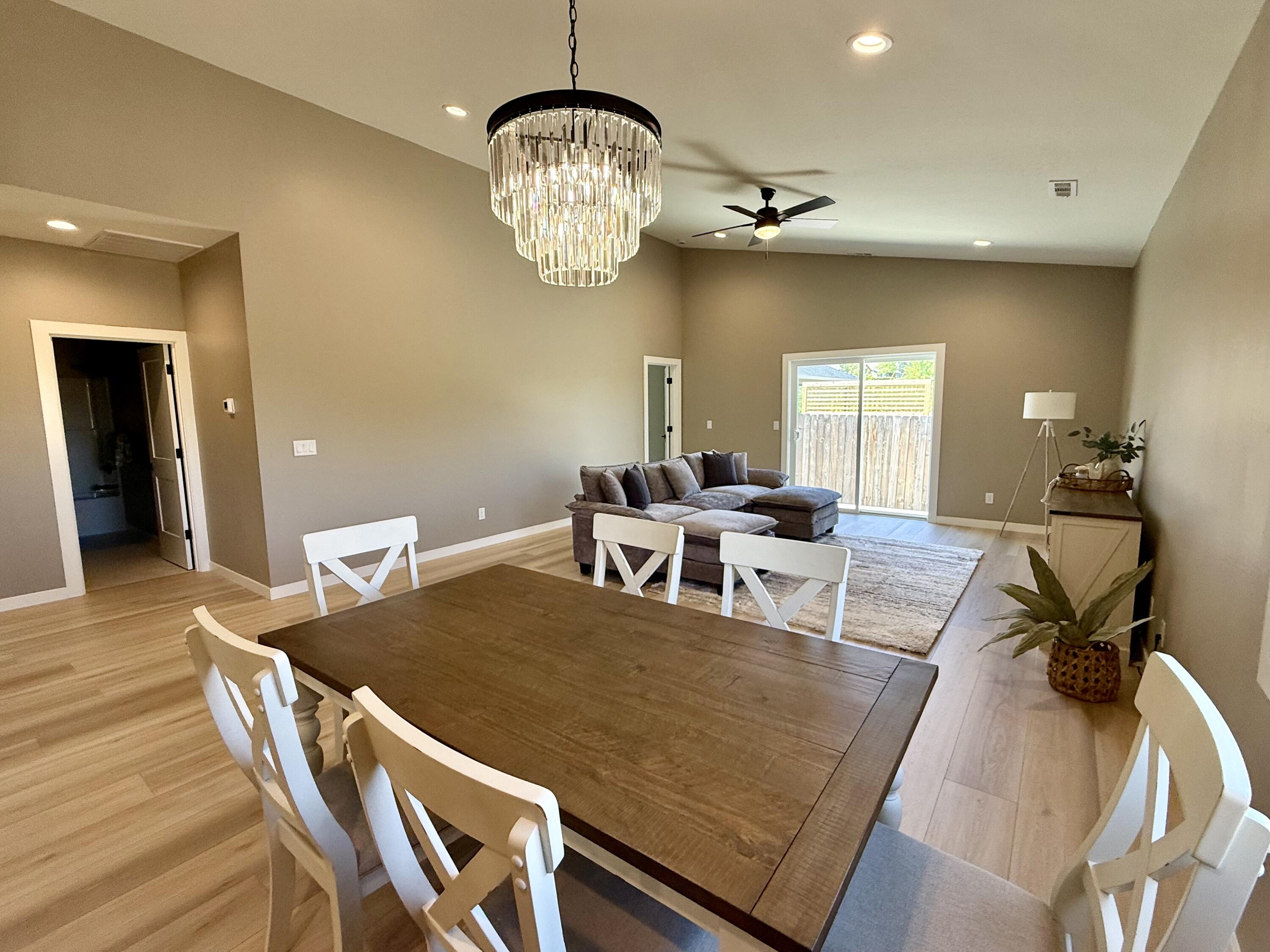 337 Quail Circle Talent, OR 97540 - Photo 9 of 25 a view of a dining room with furniture a chandelier and wooden floor