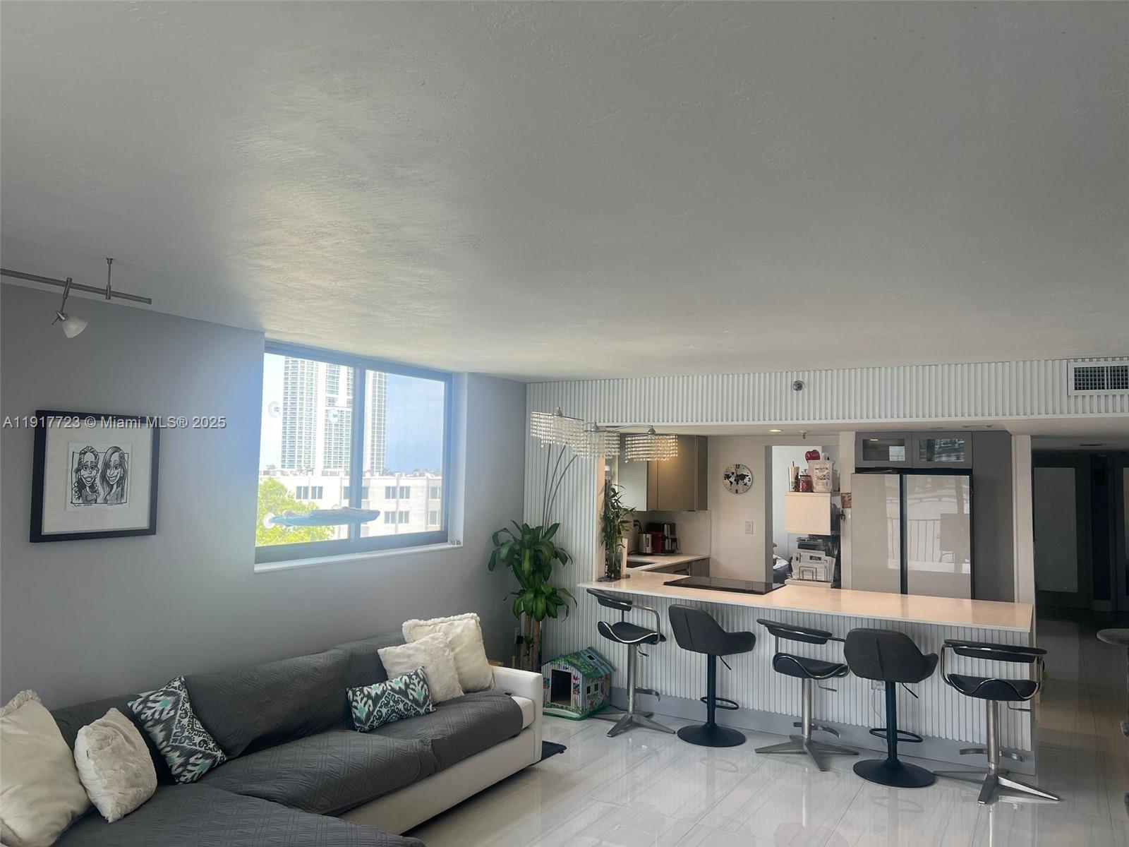 17878 North Bay Road, Unit 507 Sunny Isles Beach, FL 33160 - Photo 23 of 47 a living room with furniture and a window