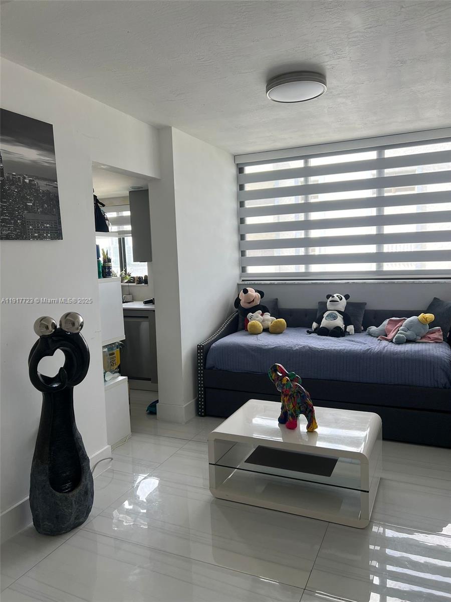 17878 North Bay Road, Unit 507 Sunny Isles Beach, FL 33160 - Photo 29 of 47 a living room with furniture and wooden floor