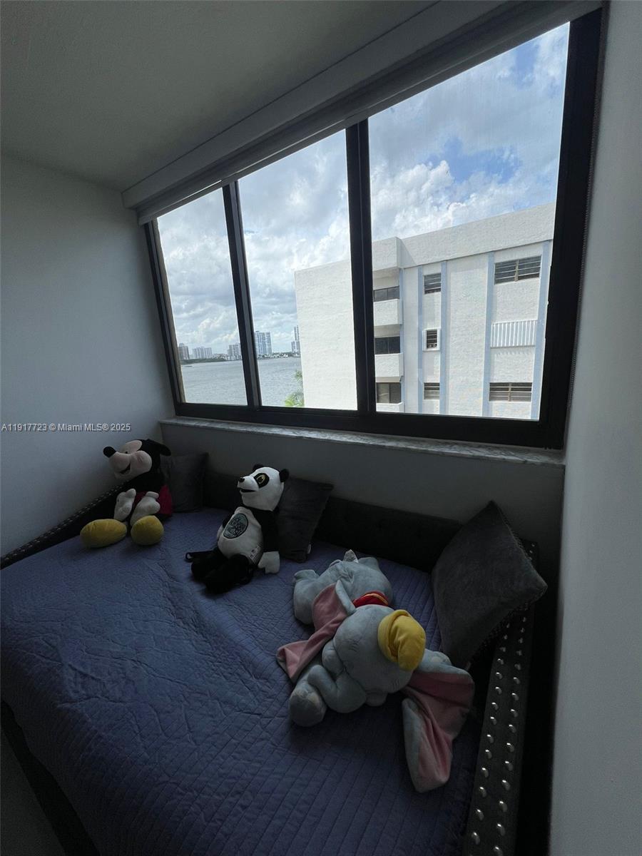 17878 North Bay Road, Unit 507 Sunny Isles Beach, FL 33160 - Photo 31 of 47 a room with furniture and a large window