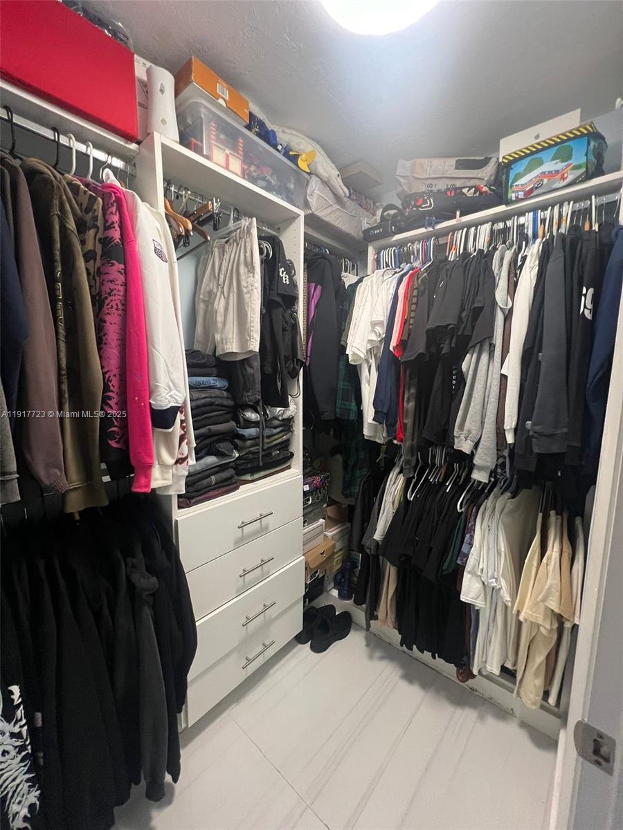 17878 North Bay Road, Unit 507 Sunny Isles Beach, FL 33160 - Photo 39 of 47 a view of walk in closet with clothes and shoes