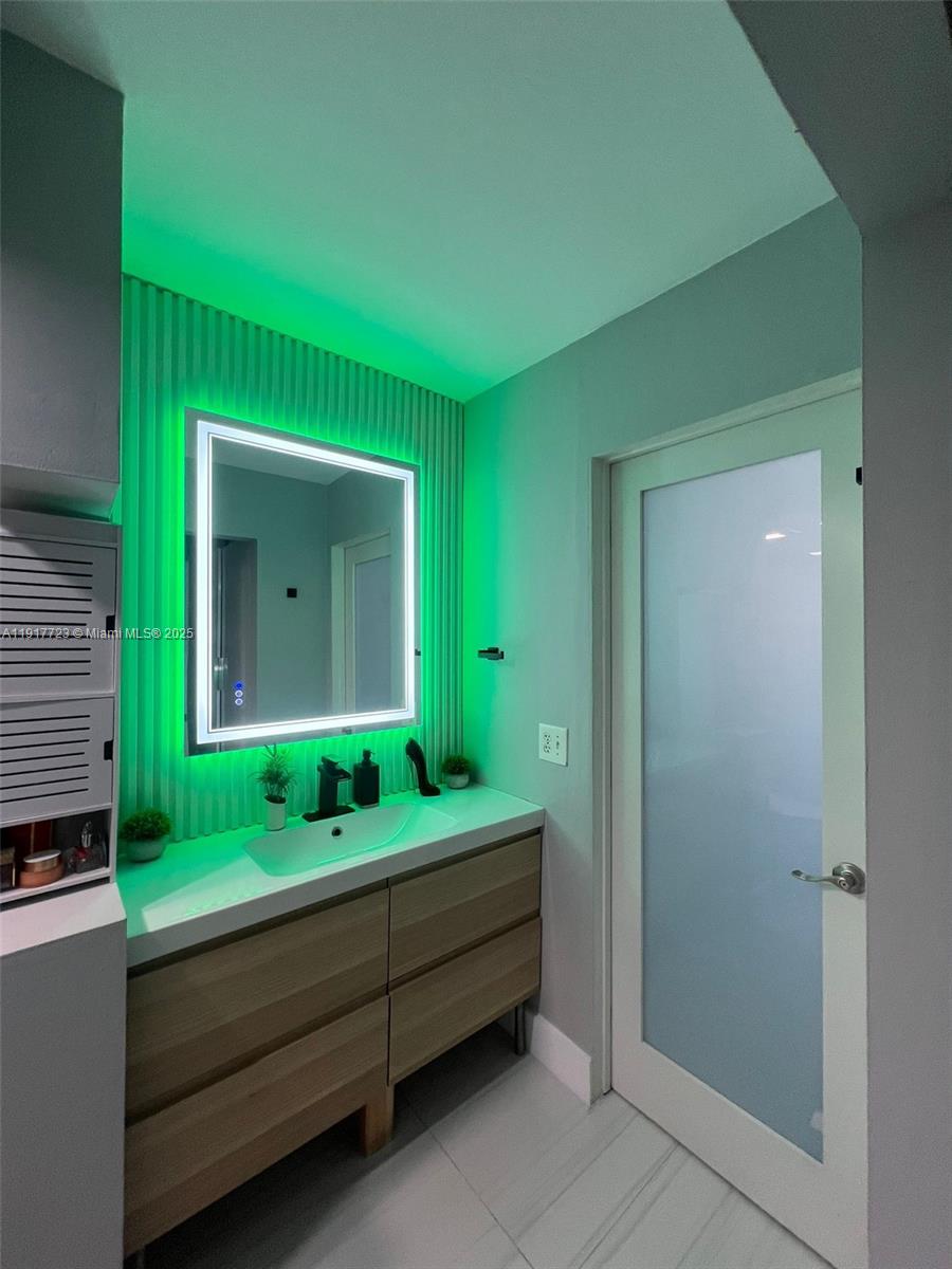 17878 North Bay Road, Unit 507 Sunny Isles Beach, FL 33160 - Photo 40 of 47 a bathroom with a sink and mirror