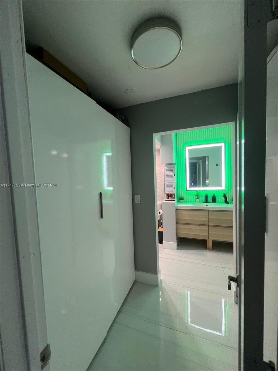 17878 North Bay Road, Unit 507 Sunny Isles Beach, FL 33160 - Photo 42 of 47 a view of a bedroom with a bed and a window