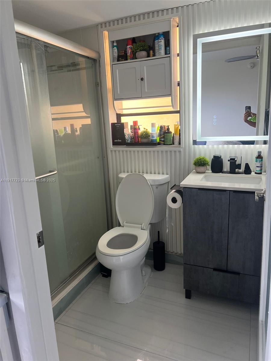 17878 North Bay Road, Unit 507 Sunny Isles Beach, FL 33160 - Photo 44 of 47 a bathroom with a toilet a sink and mirror