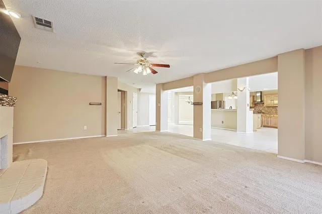 a view of an empty room with chandelier