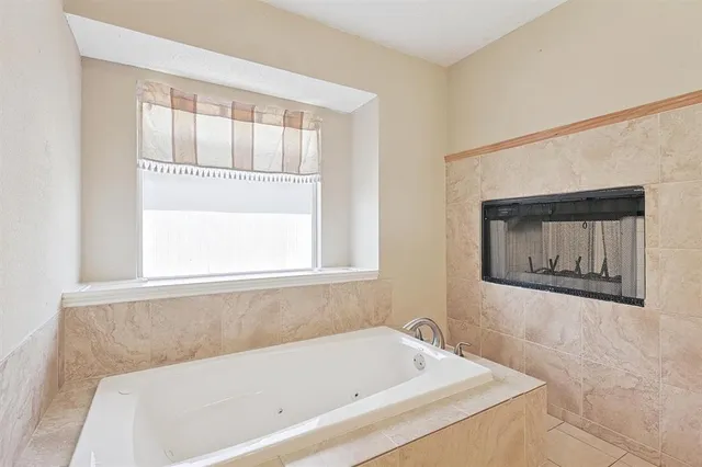 a bathroom with a bathtub and window