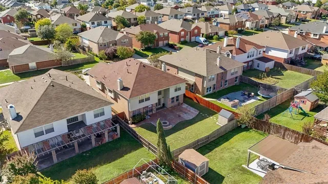 an aerial view of a house with garden space and lake view