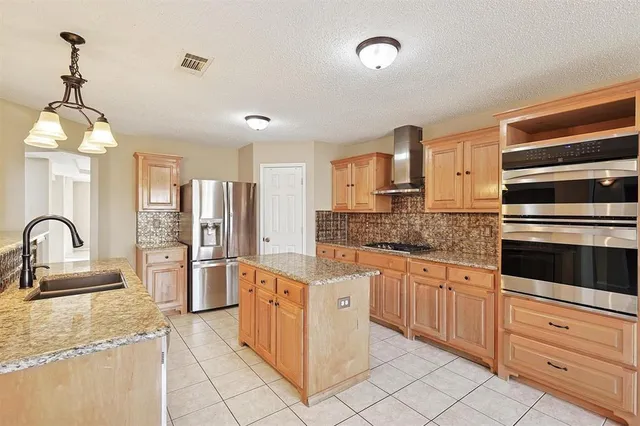 a kitchen with stainless steel appliances granite countertop a sink and cabinets
