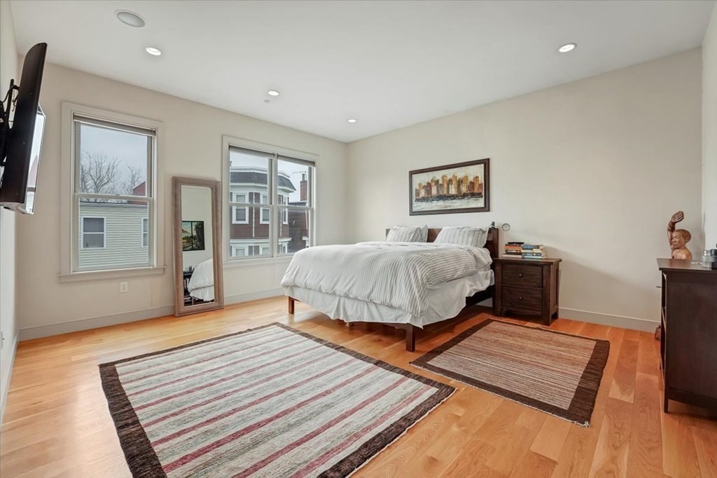 45 Vinton Street, Unit 4 Boston, MA 02127 - Photo 14 of 28 a bedroom with a bed and wooden floor