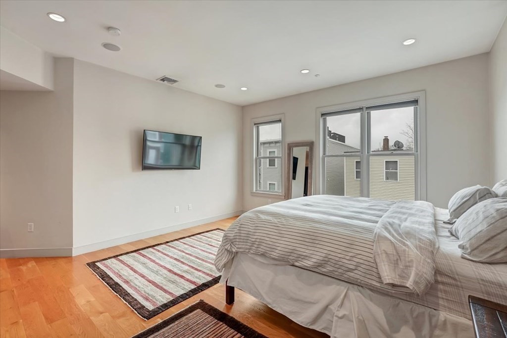 45 Vinton Street, Unit 4 Boston, MA 02127 - Photo 16 of 28 a bedroom with a bed and a large window