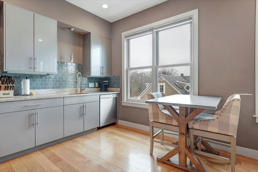 45 Vinton Street, Unit 4 Boston, MA 02127 - Photo 4 of 28 a kitchen with a table chairs sink and cabinets