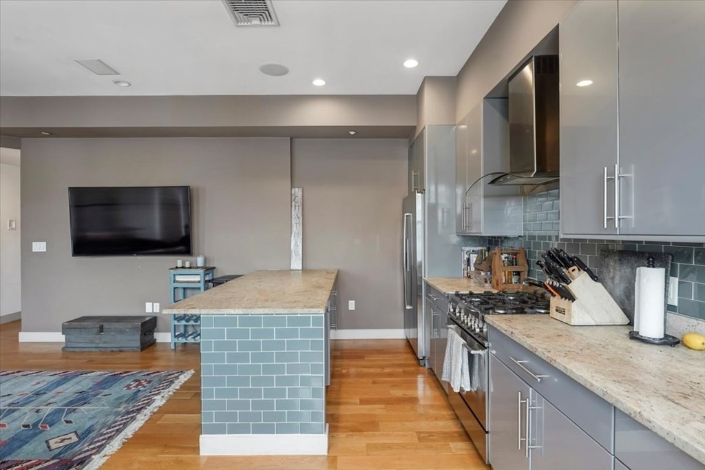 45 Vinton Street, Unit 4 Boston, MA 02127 - Photo 5 of 28 a kitchen with stainless steel appliances granite countertop a sink stove and refrigerator