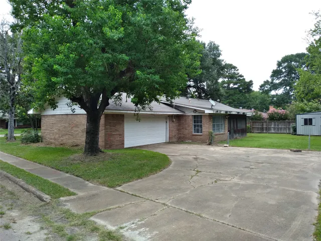 a front view of a house with a yard and a garage