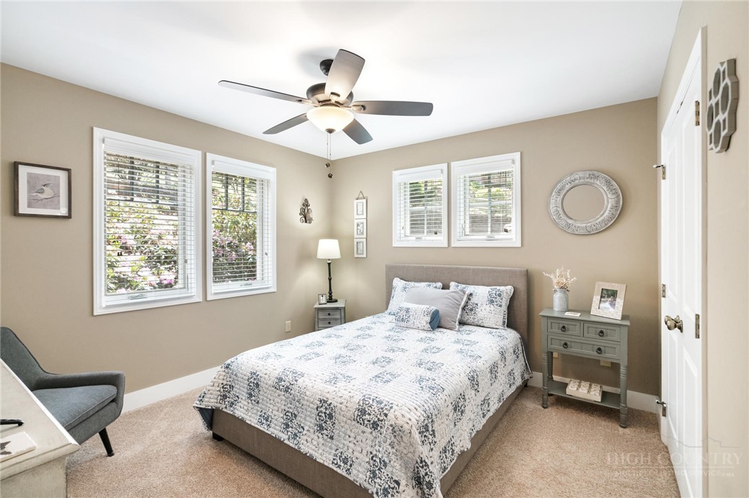 942 Ridge Haven Parkway, Unit R1211 Banner Elk, NC 28604 - Photo 26 of 45 a bedroom with a large bed and a chandelier