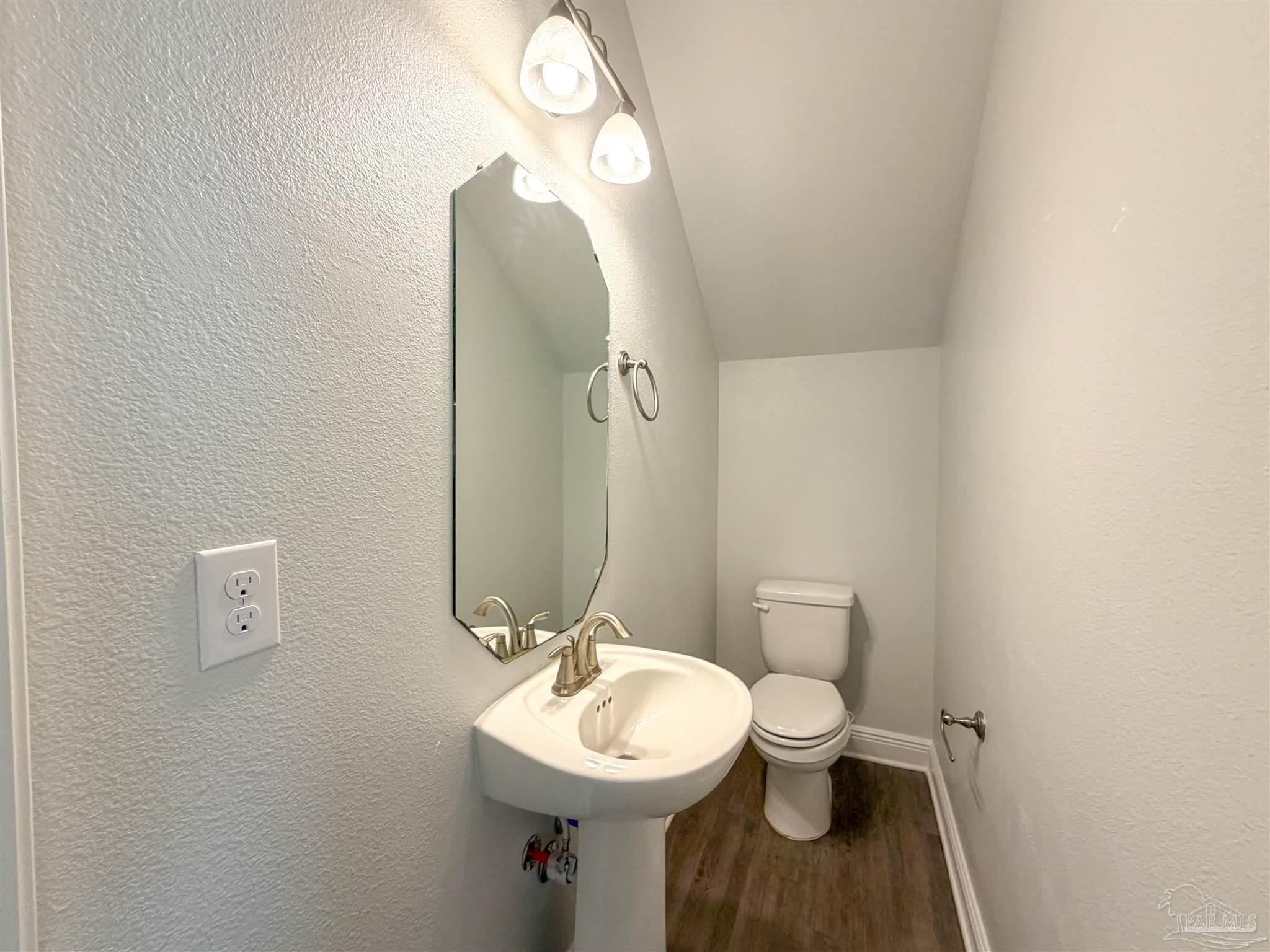 3613 Conley Drive Cantonment, FL 32533 - Photo 9 of 32 a bathroom with a toilet sink and mirror