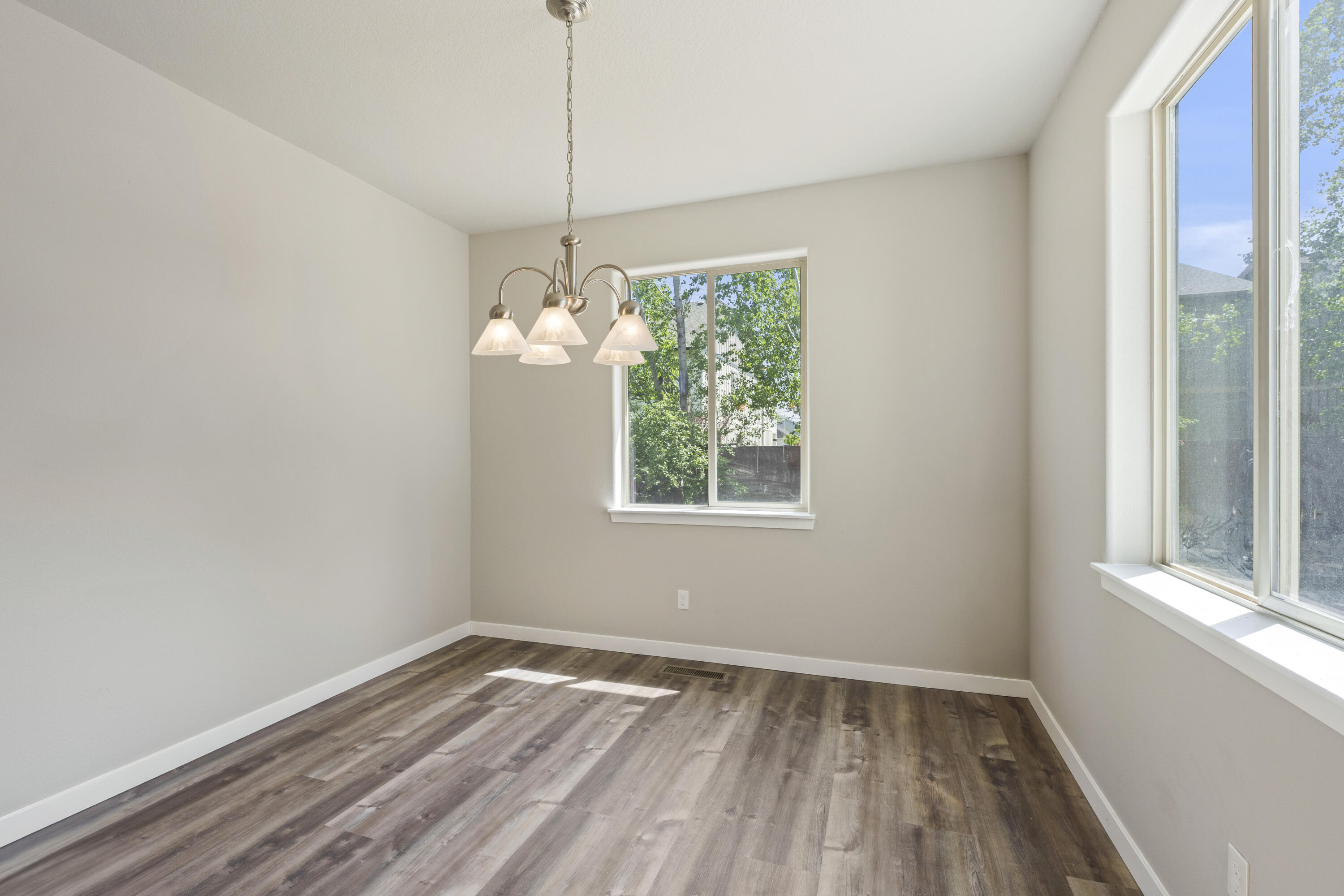 21189 Ritz Place Bend, OR 97702 - Photo 15 of 37 a view of an empty room with wooden floor and a window