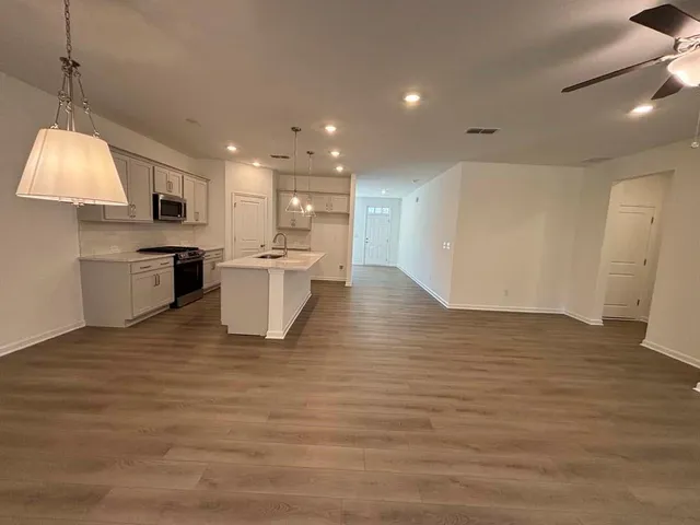 a view of a kitchen with a sink and a stove