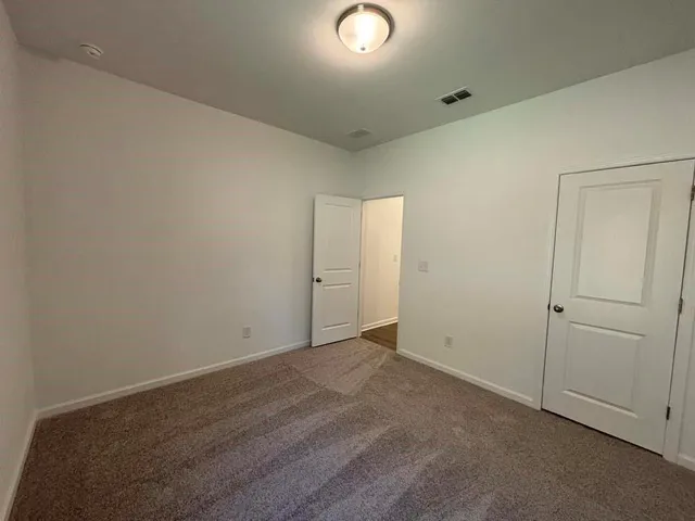 an empty room with closet area