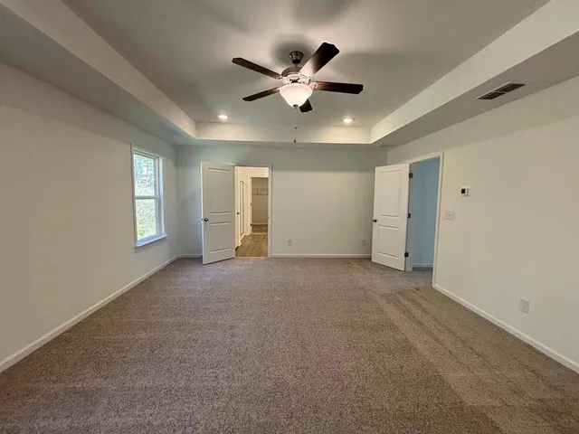 a view of an empty room with a ceiling fan