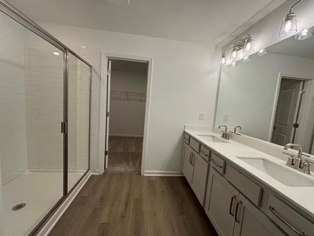 a bathroom with a double vanity sink and a mirror