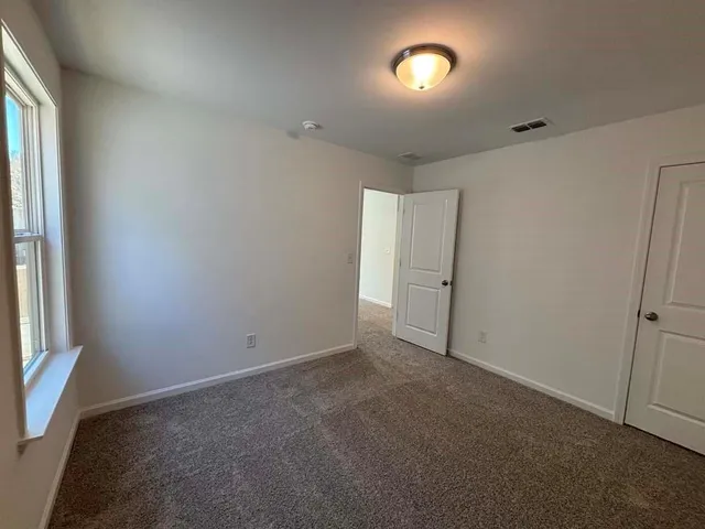 a view of wooden floor and windows in a room