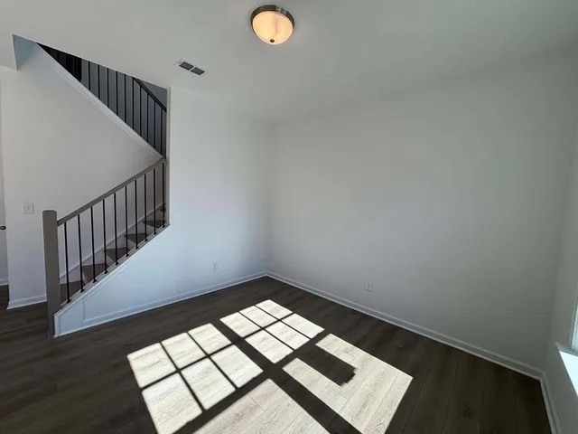 a view of an empty room and wooden floor