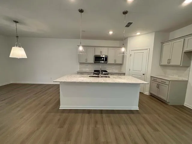 a large kitchen with stainless steel appliances kitchen island a large island in the center