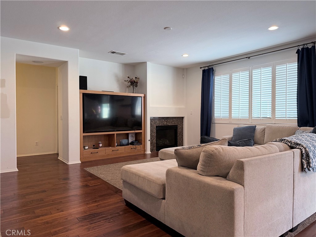 562 Quigley Lane Perris, CA 92570 - Photo 13 of 29 a living room with furniture and a flat screen tv