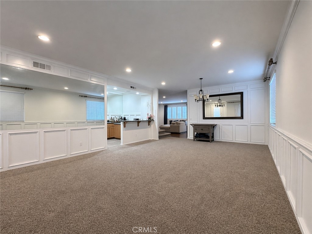 562 Quigley Lane Perris, CA 92570 - Photo 2 of 29 a view of an empty room and a kitchen with a sink window
