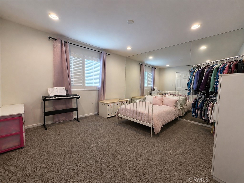 562 Quigley Lane Perris, CA 92570 - Photo 21 of 29 a bed room with a bed and a couch