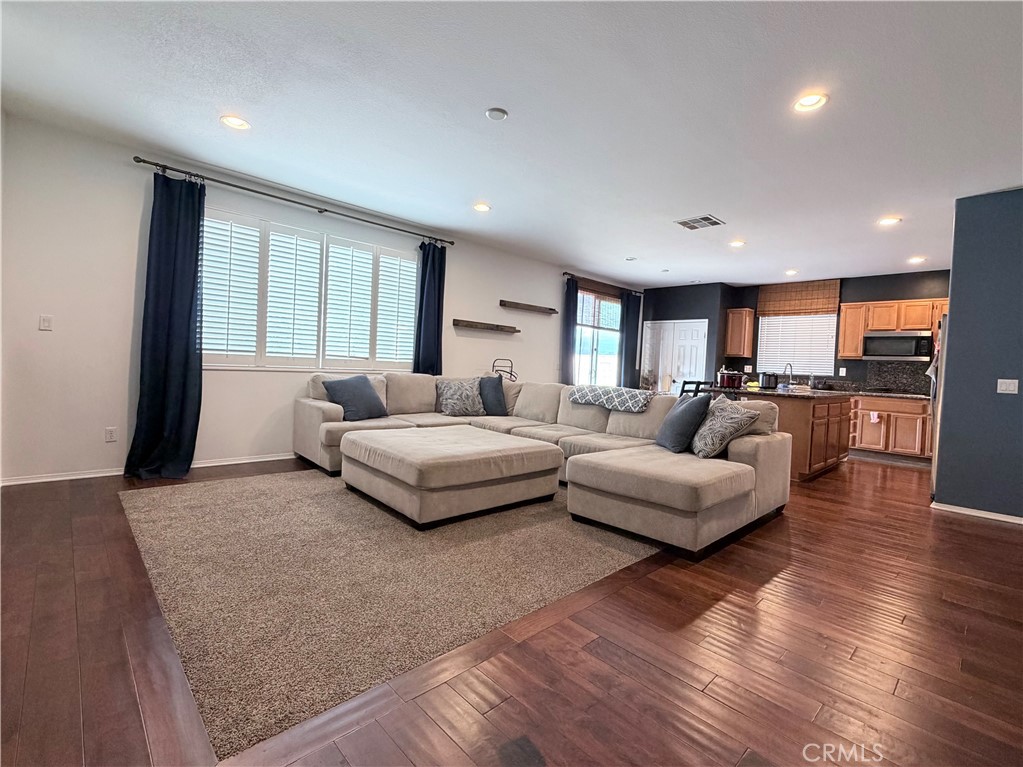 562 Quigley Lane Perris, CA 92570 - Photo 10 of 29 a spacious bedroom with a large bed and a couch