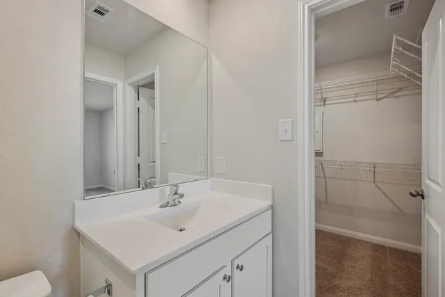 a bathroom with a sink toilet and vanity
