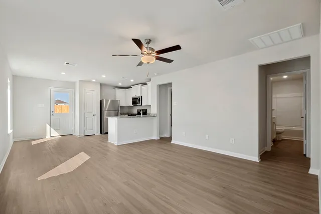 a view of a kitchen with a sink and a refrigerator