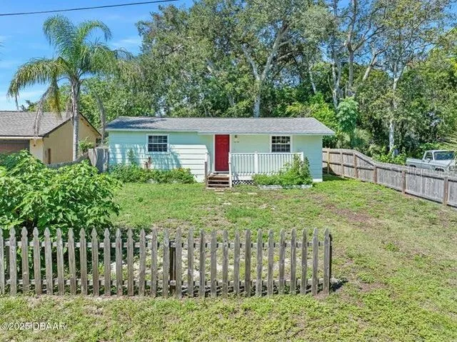 a front view of house with yard and green space