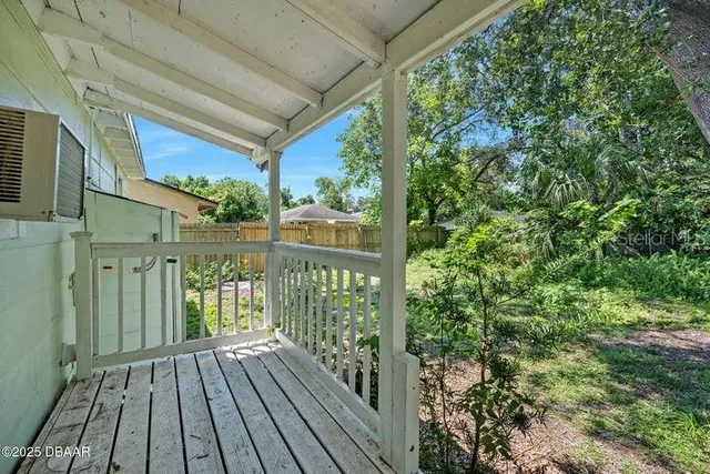 a view of a balcony with wooden floor