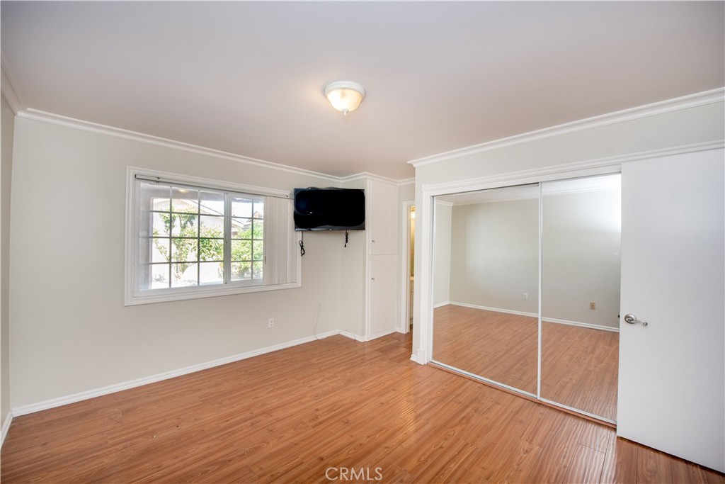 4459 Pine Street Pico Rivera, CA 90660 - Photo 28 of 38 an empty room with wooden floor and windows