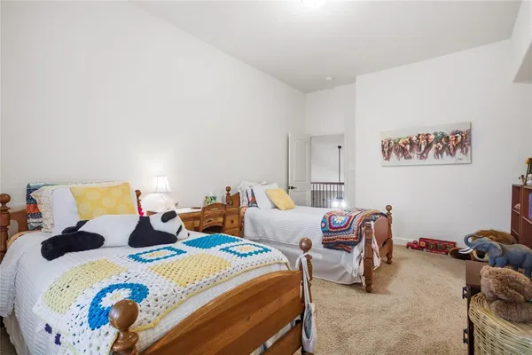 a bedroom with two beds and a couch