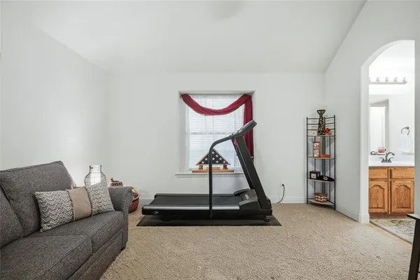 a living room with furniture a rug and white walls