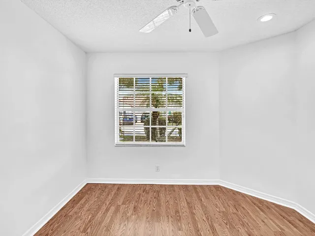 a bathroom with a granite countertop sink a toilet and a mirror