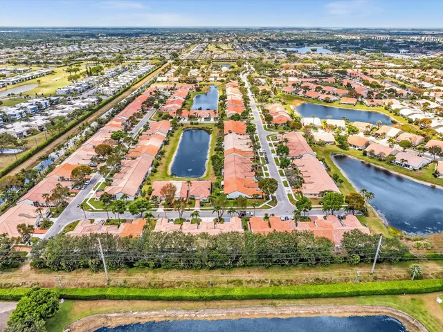 an aerial view of a house a garden and outdoor seating
