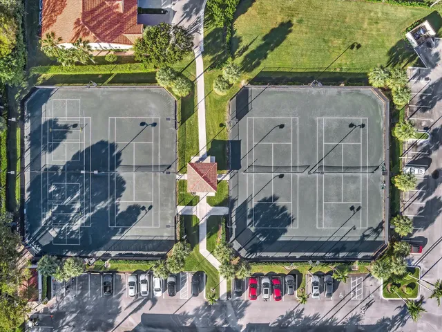 an aerial view of residential houses with outdoor space and swimming pool