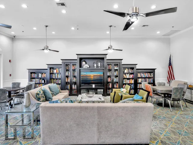 a room with stainless steel appliances kitchen island granite countertop lots of clutter