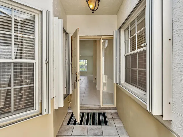 a view of a balcony with wooden floor and a potted plant