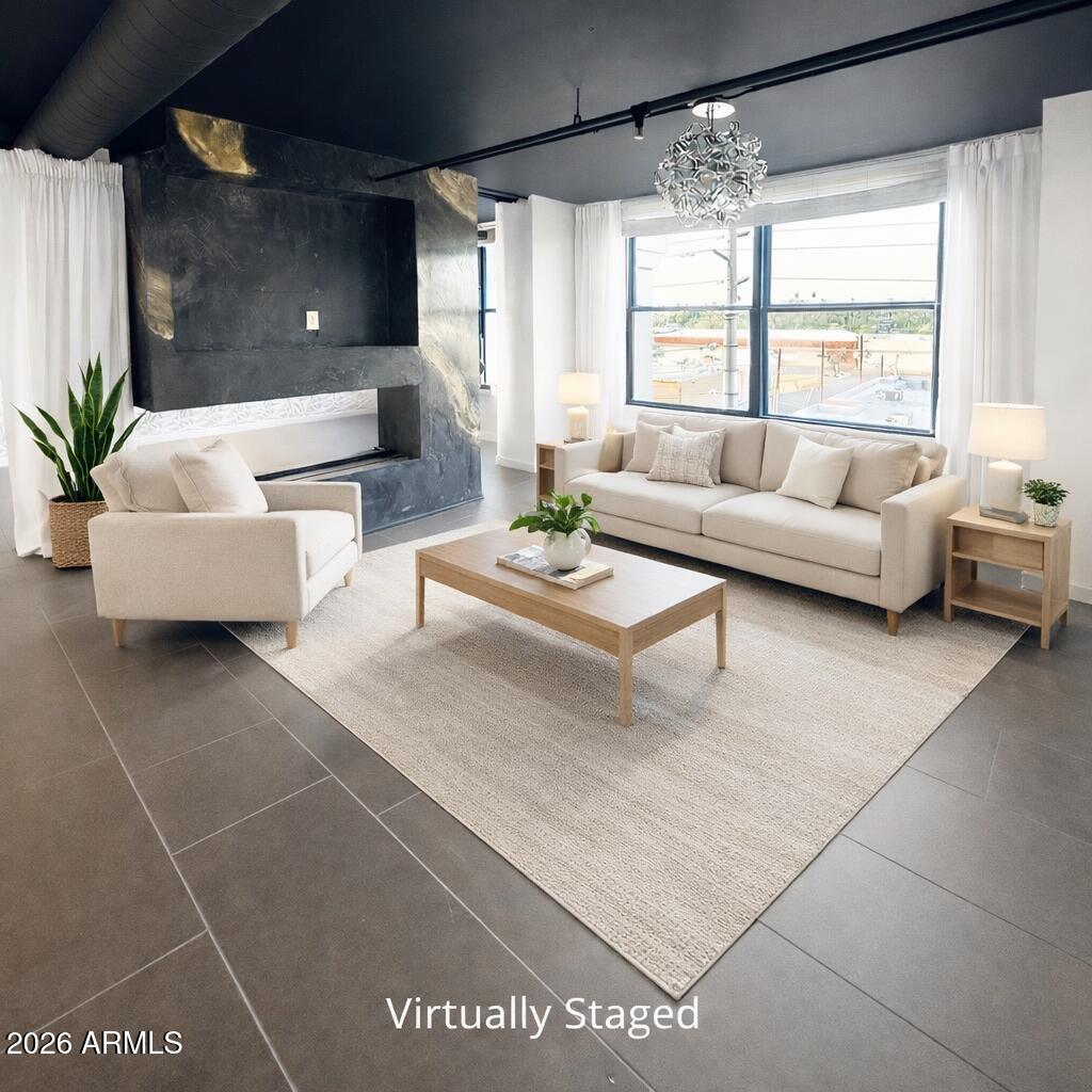 a living room with furniture and a large window