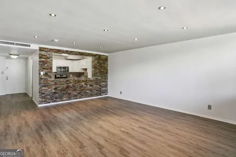 wooden floor in an empty room with a glass door