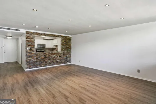 wooden floor in an empty room with a glass door