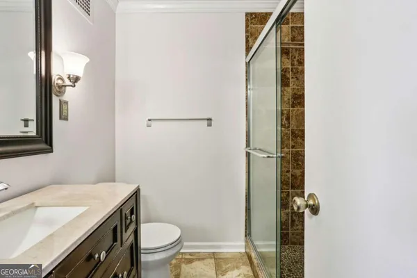 a bathroom with a sink toilet and mirror